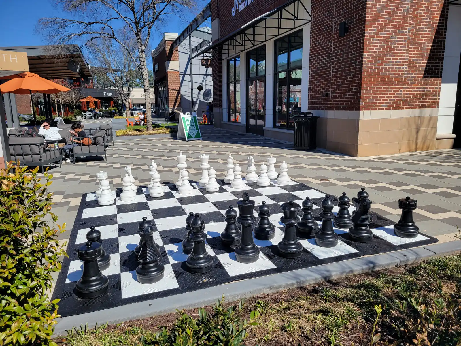 Outdoor seating and a giant chess set in the plaza at Avenue East Cobb on Roswell Road